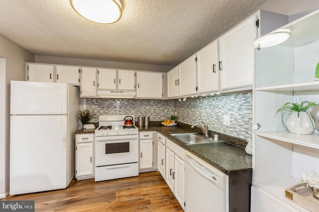 11833 Shire Ct Unit 12C, Reston, VA 20191 - kitchen featuring white appliances, a sink, under cabinet range hood, dark countertops, and a textured ceiling