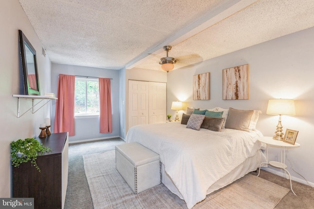 11833 Shire Ct Unit 12C, Reston, VA 20191 - bedroom with carpet floors, a textured ceiling, a closet, baseboards, and a ceiling fan