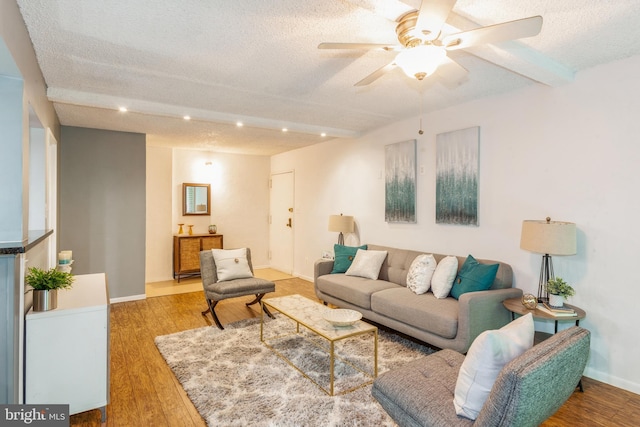 11833 Shire Ct Unit 12C, Reston, VA 20191 - living area with a textured ceiling, beam ceiling, wood finished floors, a ceiling fan, and baseboards