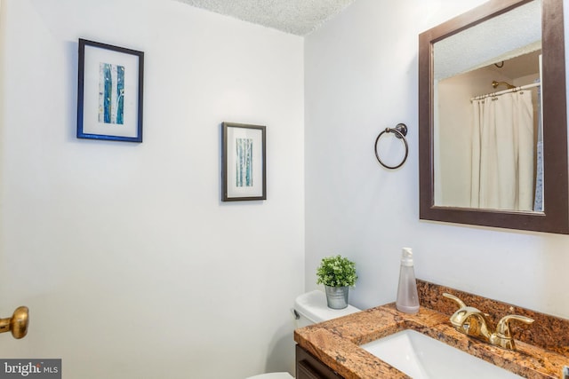 11833 Shire Ct Unit 12C, Reston, VA 20191 - bathroom with vanity, a textured ceiling, and toilet