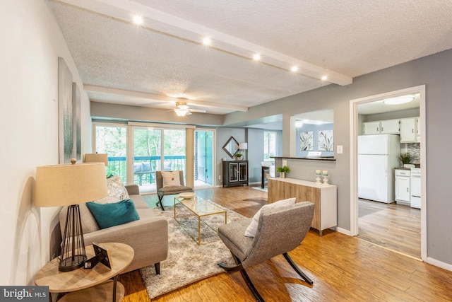 11833 Shire Ct Unit 12C, Reston, VA 20191 - living area with a textured ceiling, light wood finished floors, ceiling fan, baseboards, and beam ceiling