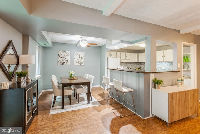 11833 Shire Ct Unit 12C, Reston, VA 20191 - dining space with light wood-style floors, ceiling fan, a textured ceiling, and baseboards