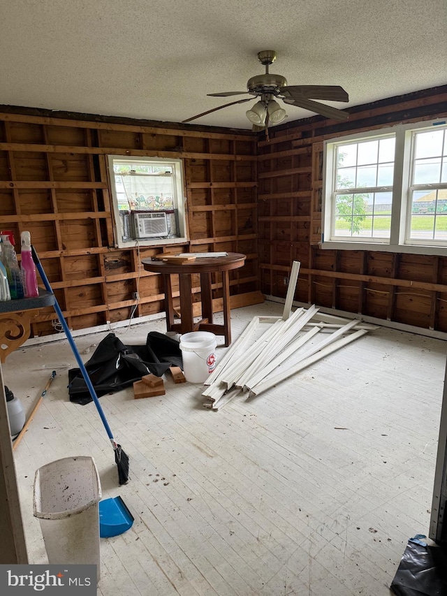 4293 Willow Grove Rd, Camden Wyoming, DE 19934 - spare room with a textured ceiling, a ceiling fan, wooden walls, and cooling unit
