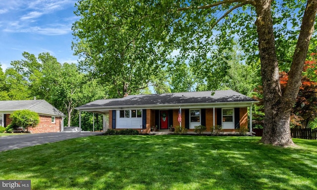 7631 Kingsbury Rd, Alexandria, VA 22315 - single story home with asphalt driveway, an attached carport, brick siding, and covered porch
