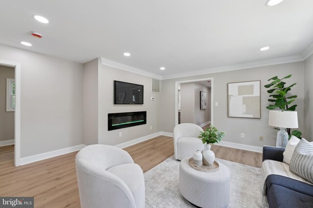 3521 Forestdale Ave, Woodbridge, VA 22193 - living area with light wood-style flooring, a glass covered fireplace, recessed lighting, baseboards, and ornamental molding