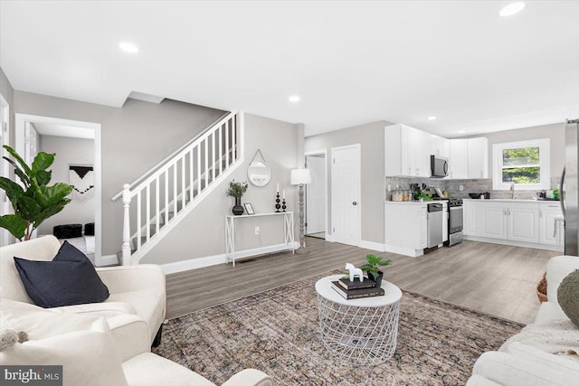 200 S Longcross Rd, Linthicum Heights, MD 21090 - living area featuring light wood-style flooring, stairs, baseboards, and recessed lighting