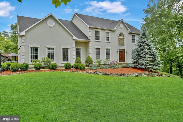34905 Gidney Ct, Round Hill, VA 20141 - view of front of home featuring a front yard, roof with shingles, and stucco siding