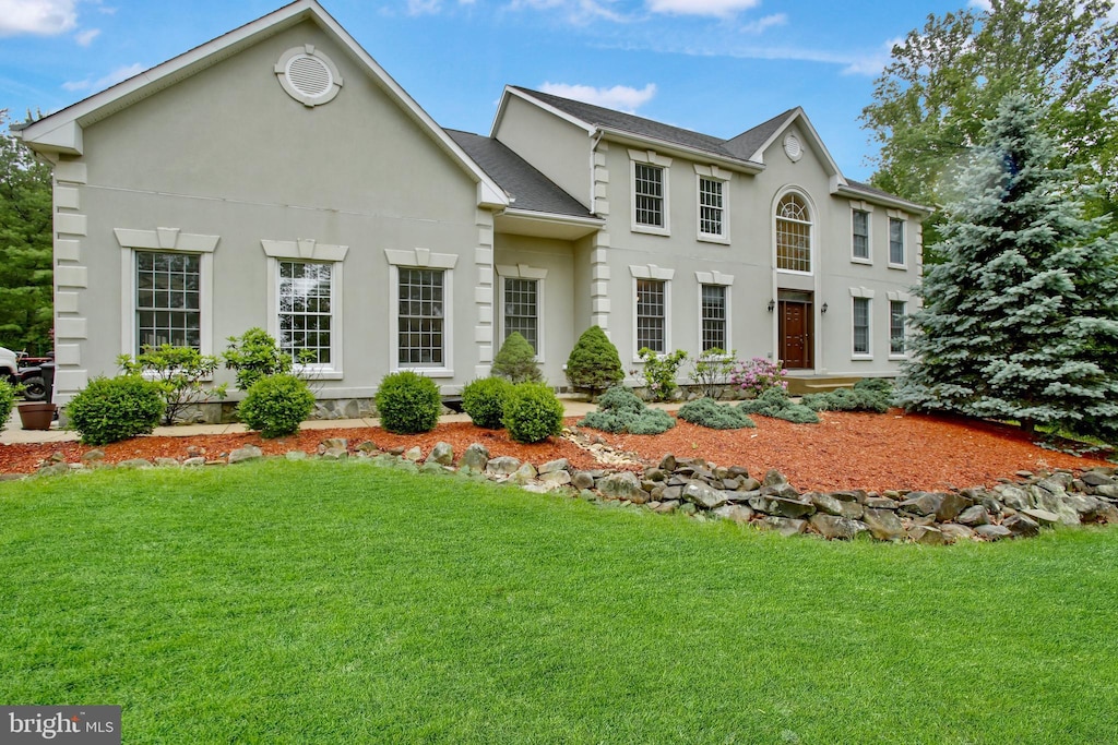 34905 Gidney Ct, Round Hill, VA 20141 - view of front of home featuring stucco siding, a front lawn, and a shingled roof