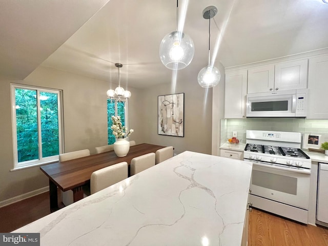5041 7th Rd S Unit 102, Arlington, VA 22204 - kitchen with white appliances, backsplash, white cabinets, decorative light fixtures, and light stone countertops