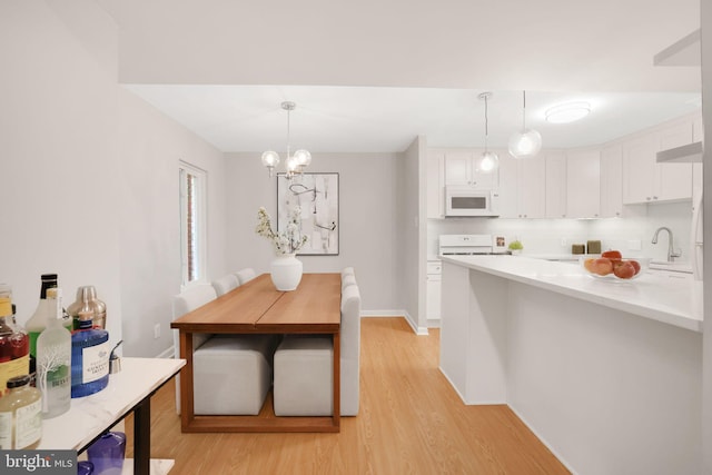 5041 7th Rd S Unit 102, Arlington, VA 22204 - dining space with light wood-type flooring, a chandelier, and baseboards