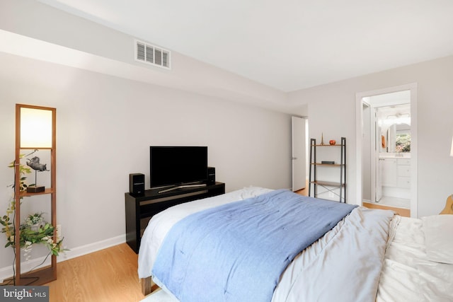 5041 7th Rd S Unit 102, Arlington, VA 22204 - bedroom with light wood-style floors, baseboards, and connected bathroom