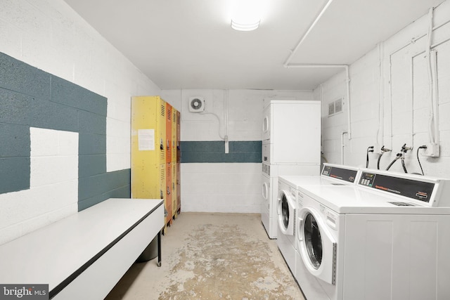 5041 7th Rd S Unit 102, Arlington, VA 22204 - shared laundry featuring stacked washer / drying machine, washer and clothes dryer, and concrete block wall