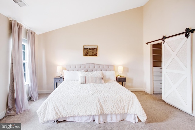 2505 Basin View Ln, Woodbridge, VA 22191 - carpeted bedroom with a barn door, baseboards, and high vaulted ceiling