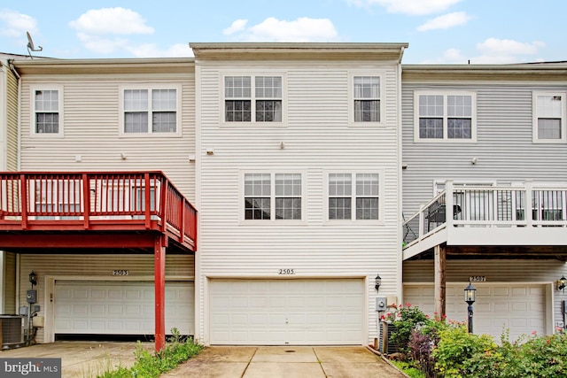 2505 Basin View Ln, Woodbridge, VA 22191 - back of property featuring an attached garage, concrete driveway, a deck, and central AC unit