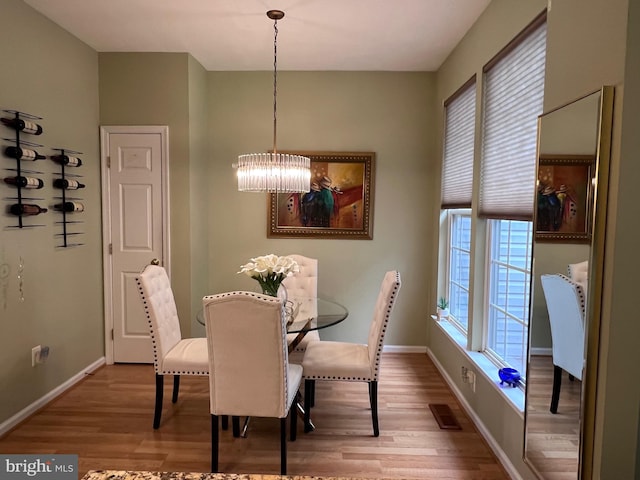 7884 Seafarer Way, Lorton, VA 22079 - dining room with a chandelier, wood finished floors, and baseboards