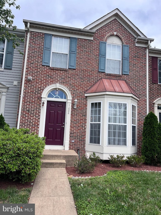 7884 Seafarer Way, Lorton, VA 22079 - view of front facade featuring brick siding and a standing seam roof