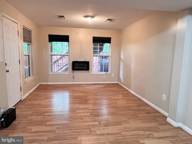 7884 Seafarer Way, Lorton, VA 22079 - unfurnished living room with light wood-style floors, baseboards, and a glass covered fireplace