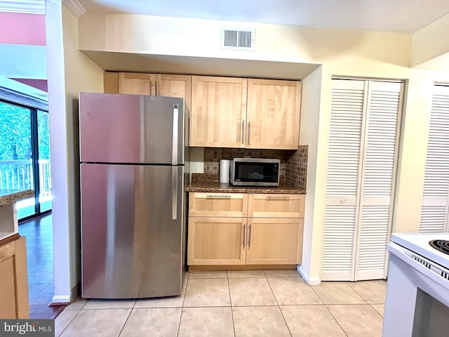 9717 Kings Crown Ct Unit 201, Fairfax, VA 22031 - kitchen with stainless steel appliances, light tile patterned floors, light brown cabinets, and tasteful backsplash
