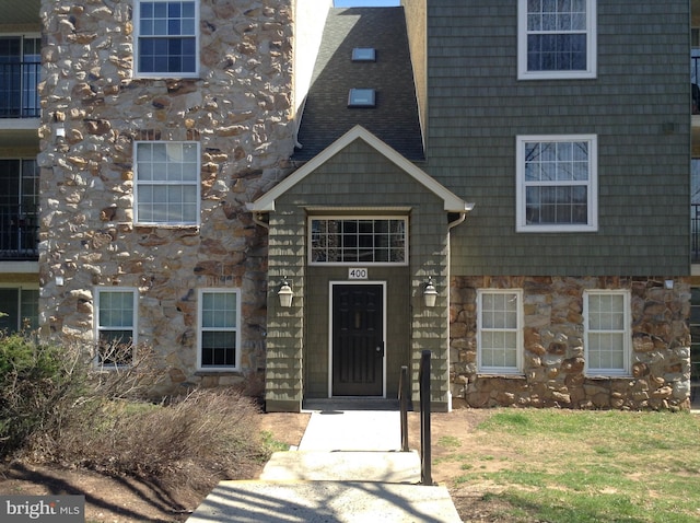 406 Deer Run, Norristown, PA 19403 - view of exterior entry featuring stone siding and a chimney
