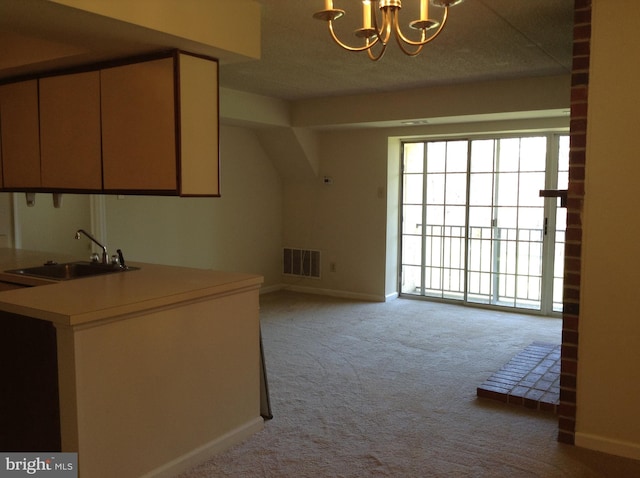 406 Deer Run, Norristown, PA 19403 - kitchen with a sink, a chandelier, carpet, baseboards, and light countertops