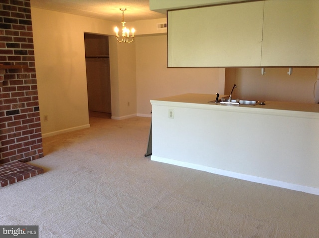 406 Deer Run, Norristown, PA 19403 - kitchen featuring light carpet, a sink, a chandelier, baseboards, and pendant lighting
