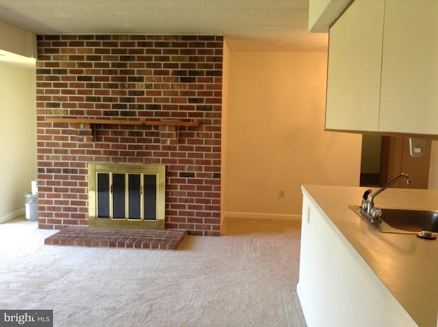 406 Deer Run, Norristown, PA 19403 - unfurnished living room featuring a sink, carpet, baseboards, and a brick fireplace