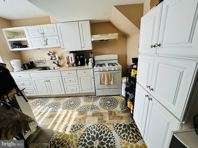 413 S Andrews Ave, Glenolden, PA 19036 - kitchen featuring white gas stove, under cabinet range hood, a sink, and white cabinetry