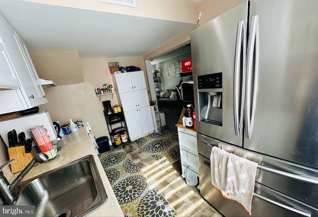 413 S Andrews Ave, Glenolden, PA 19036 - kitchen featuring stainless steel fridge with ice dispenser, a sink, light countertops, and white cabinets