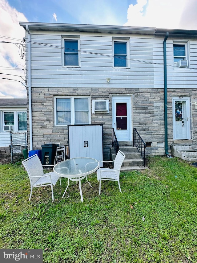 413 S Andrews Ave, Glenolden, PA 19036 - rear view of property with entry steps, stone siding, and a yard