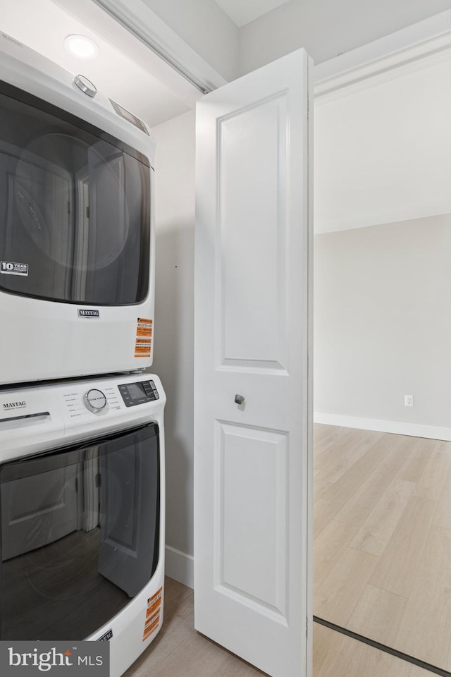 37 Anglin Dr, Newark, DE 19713 - laundry room with stacked washing machine and dryer, light wood-style floors, and baseboards