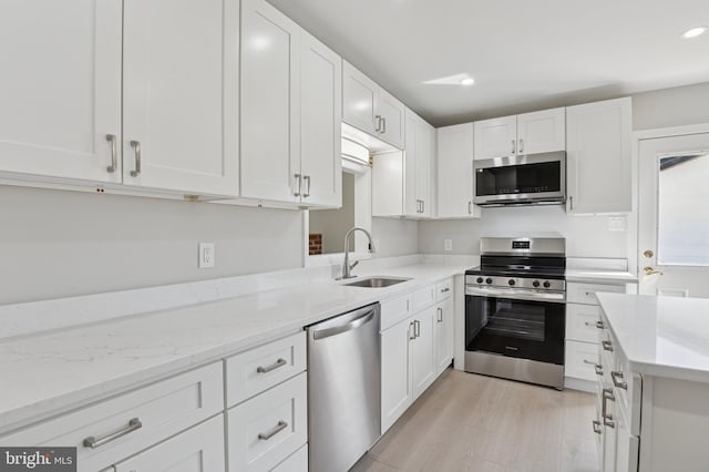 37 Anglin Dr, Newark, DE 19713 - kitchen featuring stainless steel appliances, a sink, white cabinetry, recessed lighting, and light stone counters