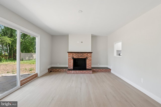 37 Anglin Dr, Newark, DE 19713 - unfurnished living room featuring wood finished floors, a brick fireplace, and baseboards