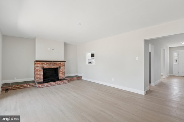 37 Anglin Dr, Newark, DE 19713 - unfurnished living room with light wood-style floors, baseboards, and a brick fireplace