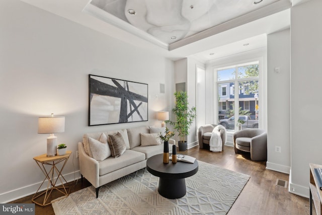 652 L St NE Unit 1, Washington, DC 20002 - living room featuring baseboards, wood finished floors, and a tray ceiling