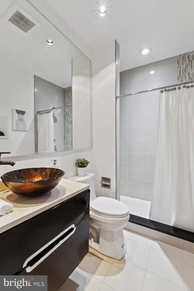 652 L St NE Unit 1, Washington, DC 20002 - bathroom featuring a tile shower, vanity, toilet, tile patterned flooring, and recessed lighting