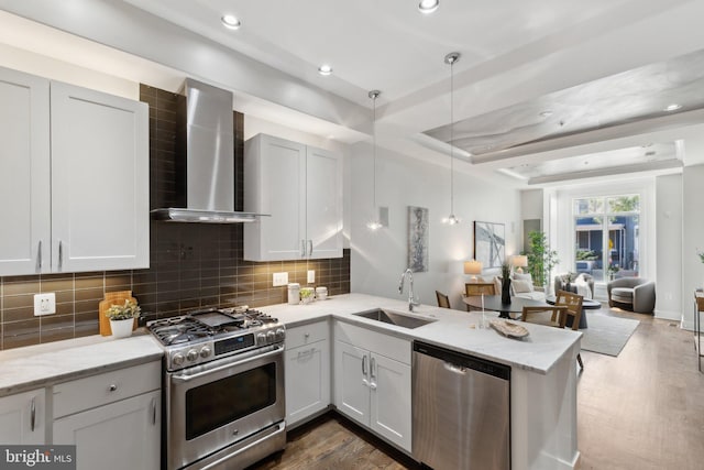 652 L St NE Unit 1, Washington, DC 20002 - kitchen with appliances with stainless steel finishes, wall chimney exhaust hood, a sink, open floor plan, and backsplash