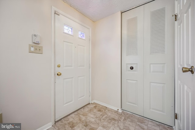 19256 Misty Meadow Ter, Germantown, MD 20874 - foyer featuring a textured ceiling and baseboards