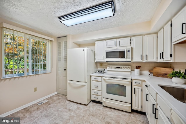 19256 Misty Meadow Ter, Germantown, MD 20874 - kitchen featuring white appliances, light countertops, a textured ceiling, baseboards, and tasteful backsplash