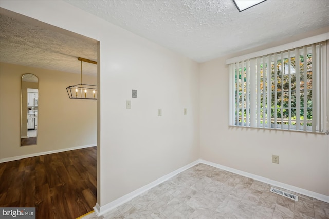19256 Misty Meadow Ter, Germantown, MD 20874 - empty room featuring a textured ceiling, a chandelier, and baseboards