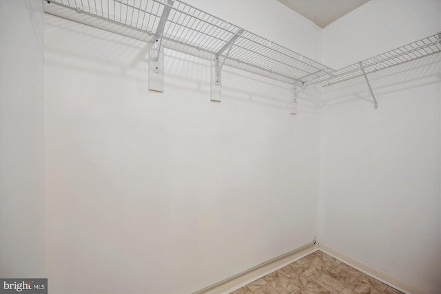 19256 Misty Meadow Ter, Germantown, MD 20874 - walk in closet with light marble finish flooring