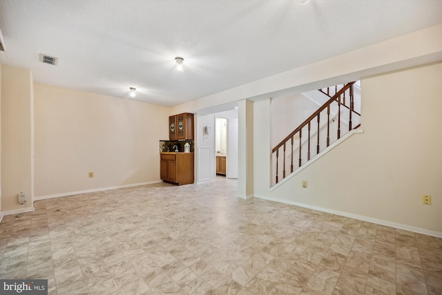 19256 Misty Meadow Ter, Germantown, MD 20874 - unfurnished living room with stairs, baseboards, and a textured ceiling