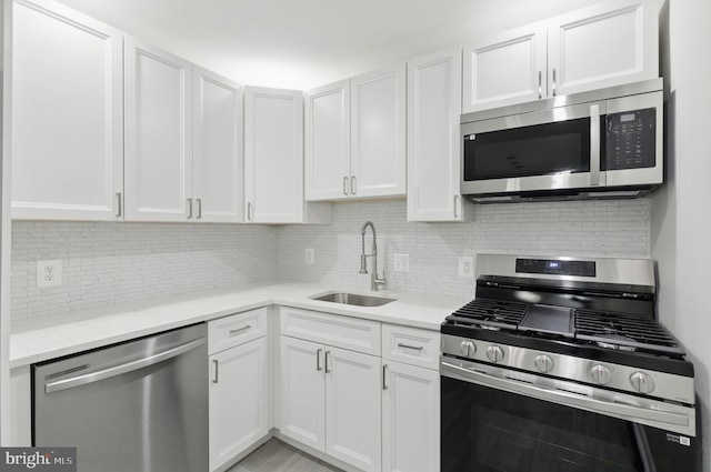 2310 Ewing Ave Unit 203, Suitland, MD 20746 - kitchen featuring stainless steel appliances, backsplash, and white cabinetry
