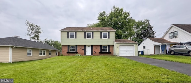 40 Marshal Ln, Willingboro, NJ 08046 - colonial home with an attached garage, brick siding, asphalt driveway, and a front lawn