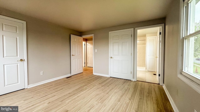 40 Marshal Ln, Willingboro, NJ 08046 - unfurnished bedroom featuring baseboards, light wood-style floors, and connected bathroom