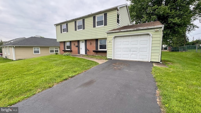 40 Marshal Ln, Willingboro, NJ 08046 - colonial-style house featuring an attached garage, brick siding, and asphalt driveway