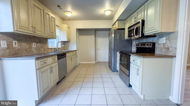 40 Marshal Ln, Willingboro, NJ 08046 - kitchen with appliances with stainless steel finishes, a sink, backsplash, light tile patterned floors, and baseboards