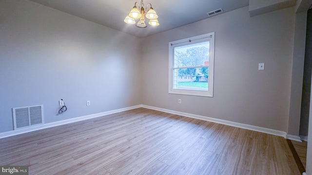 40 Marshal Ln, Willingboro, NJ 08046 - spare room featuring a chandelier, wood finished floors, and baseboards