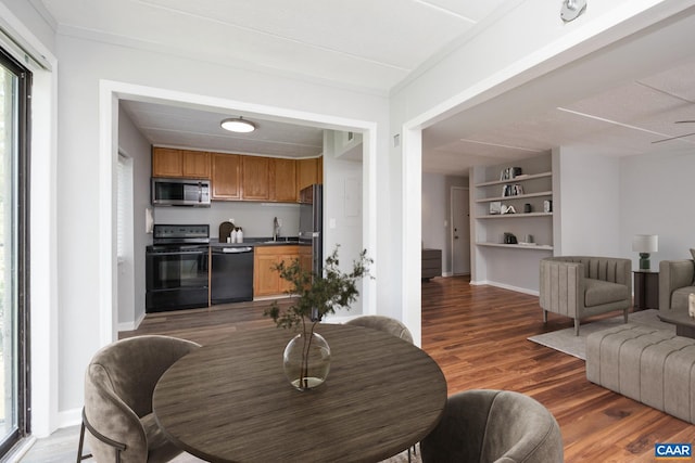 30 Spring Ct, Charlottesville, VA 22901 - living room with wood finished floors, built in shelves, and baseboards