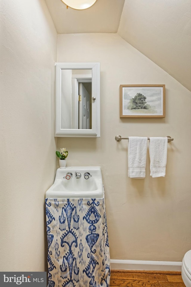 417 Gibbon St, Alexandria, VA 22314 - bathroom with vaulted ceiling, toilet, and wood finished floors