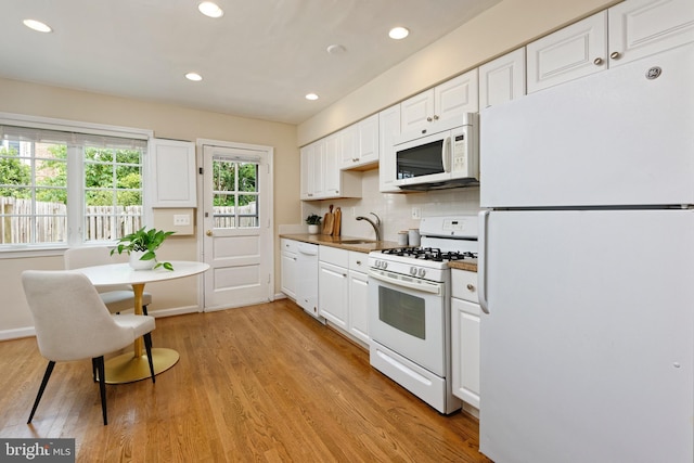 417 Gibbon St, Alexandria, VA 22314 - kitchen with white appliances, white cabinetry, recessed lighting, light wood-type flooring, and a sink